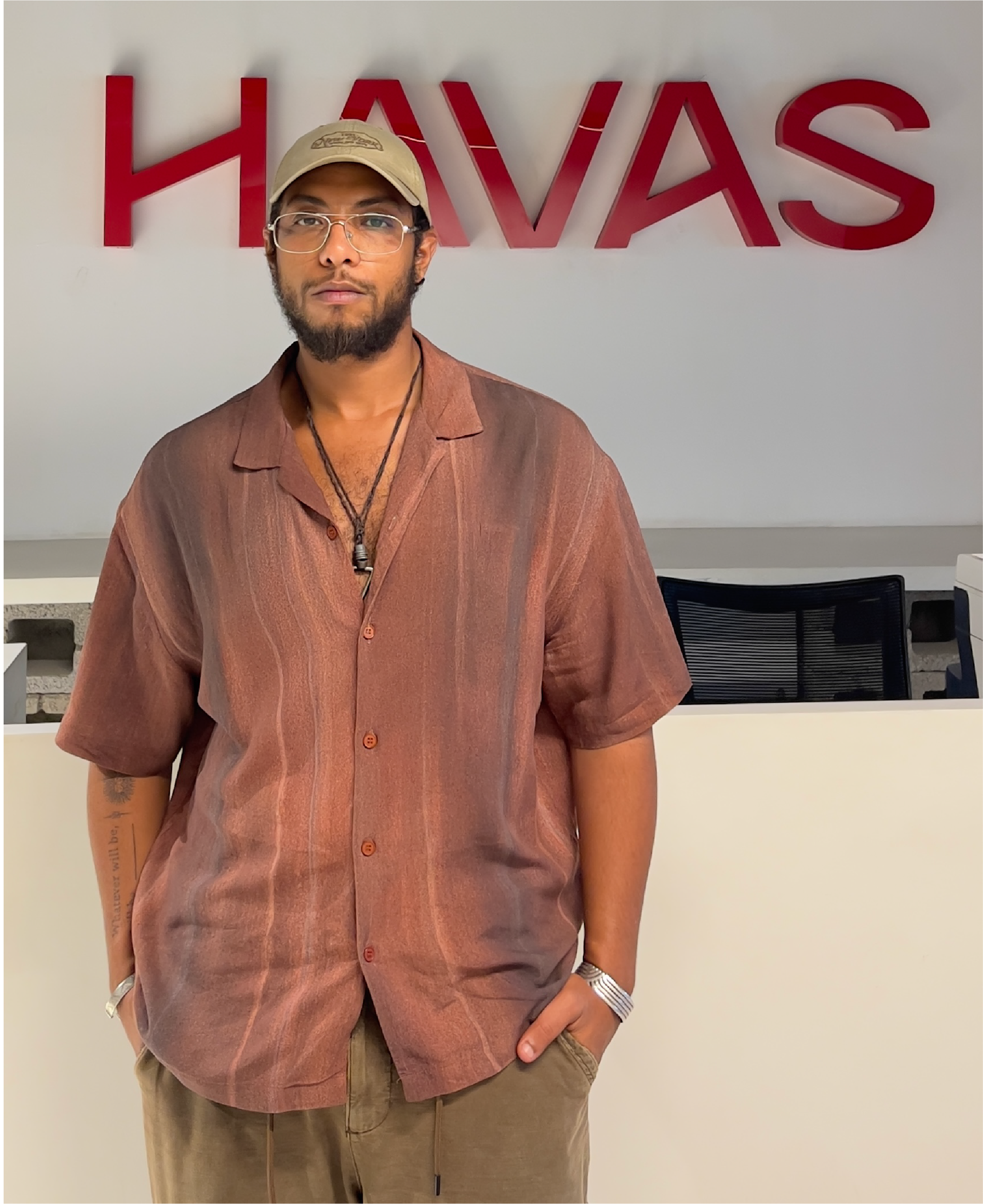 Shehab standing in front of HAVAS sign