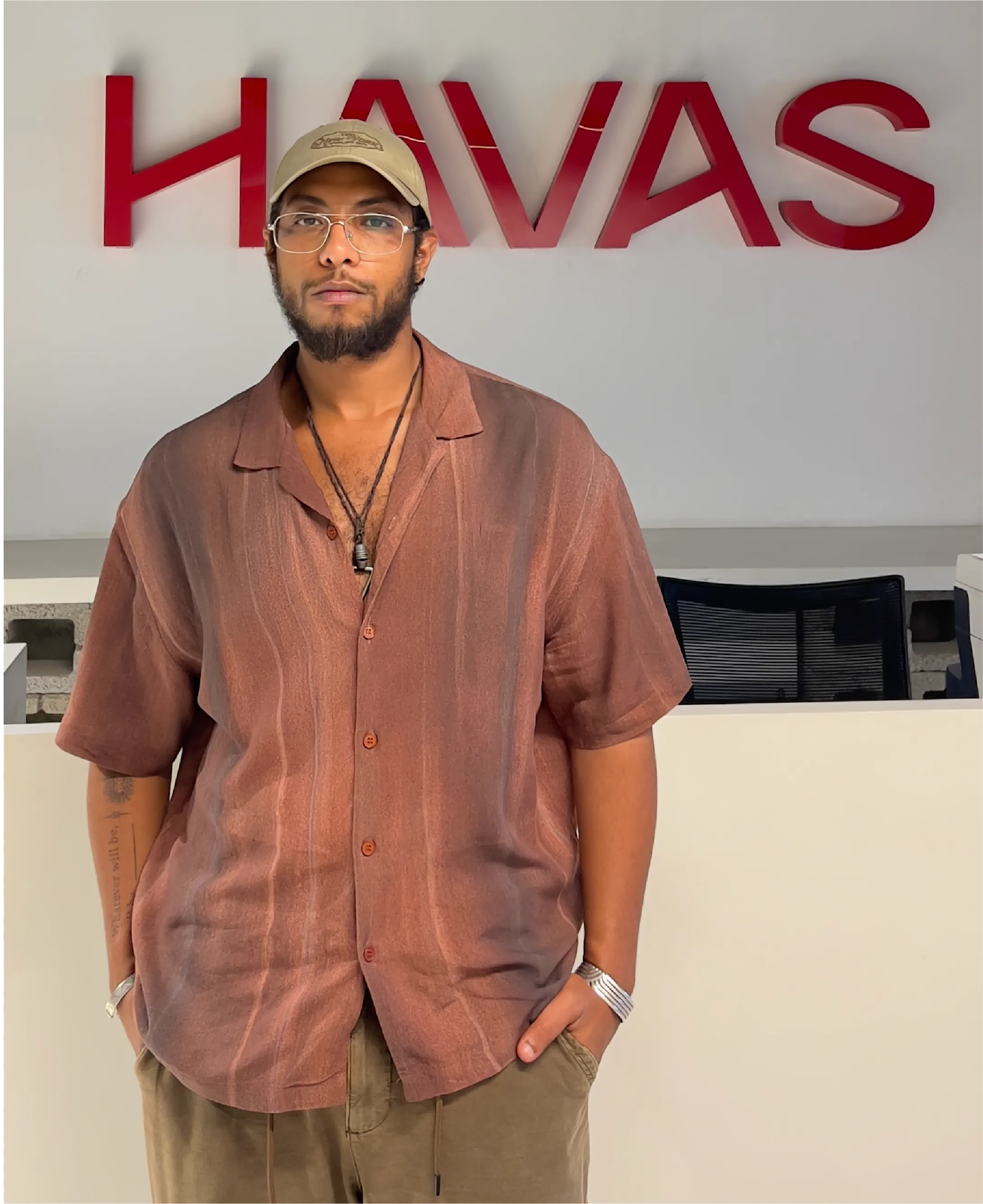 Shehab standing in front of HAVAS sign